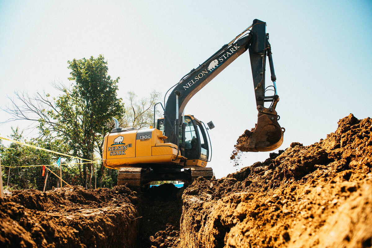 Excavator moving dirt